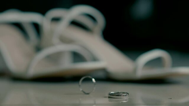 Wedding rings with white sandals of the bride. High quality FullHD footage