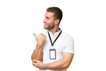 Young caucasian man with ID card isolated on green chroma background pointing to the side to present a product