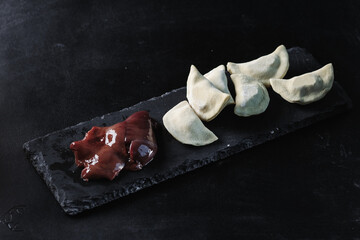 Dumplings with liver on a black background