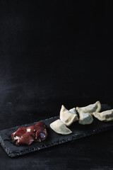 Dumplings with liver on a black background