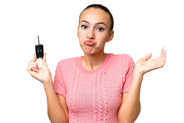 Young Arab woman holding car keys over isolated background making doubts gesture while lifting the shoulders