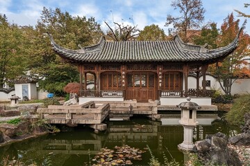 Chinese garden with a pagoda in pond in autumn Stuttgart