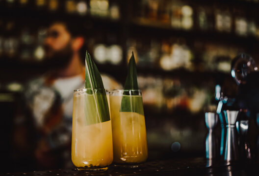 two orange alcohol cocktail in glass at the bar counter.