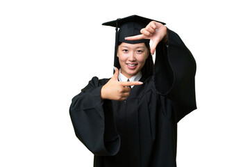 Young university graduate Asian woman over isolated background focusing face. Framing symbol