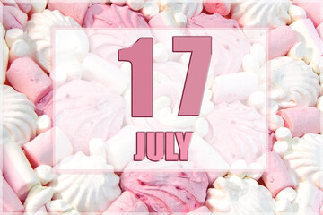 calendar date on the background of white and pink marshmallows. July 17 is the seventeenth day of...