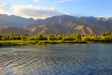Lake in the mountains. Quiet bay in the greenery at sunset. Place for rest. Kyrgyzstan, Lake...