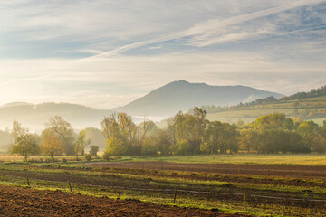 Rural landscape in an autumn foggy morning. Northwest of Slovakia, Europe.