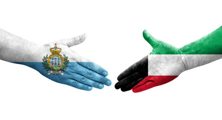 Handshake between Kuwait and San Marino flags painted on hands, isolated transparent image.