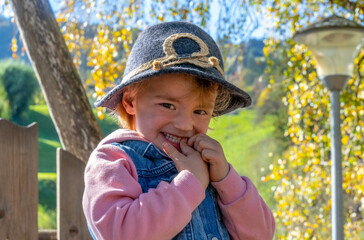 Little girl with hat smiling big time 