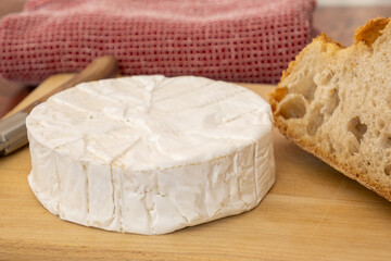 camembert entier sur une planche en bois
