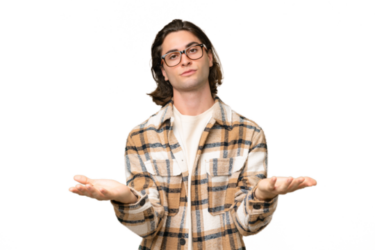 Young caucasian man isolated on green chroma background having doubts