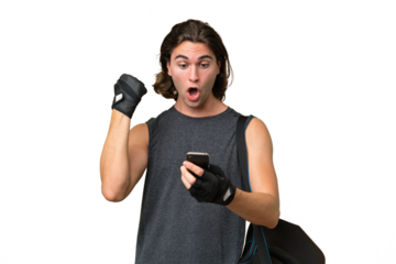 Young sport handsome man isolated on green chroma background surprised and sending a message