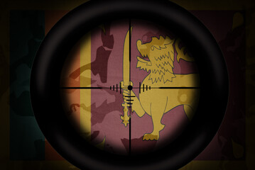 sniper scope aimed at flag of sri lanka on the khaki texture background. military concept. 3d illustration