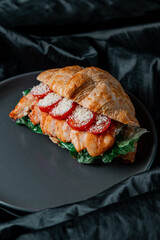 grilled salmon steak with tomato in croissant