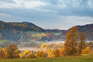 Mountain rural landscape in an autumn foggy morning. The Mala Fatra national park in northwest of Slovakia, Europe.