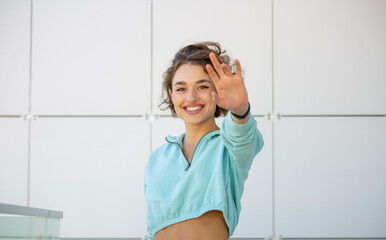 Portrait of a happy woman waving a hand