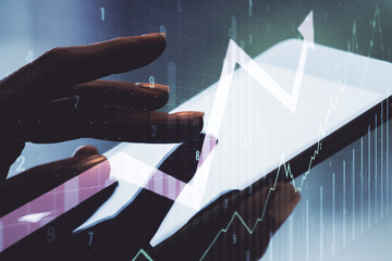 Double exposure of abstract creative financial chart with upward arrow and finger clicks on a...