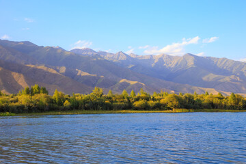Lake in the mountains. Quiet bay in the greenery at sunset. Place for rest. Kyrgyzstan, Lake...