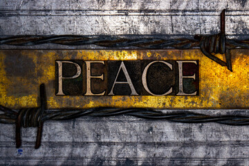 Peace text with barbed wire on grunge textured copper and gold background