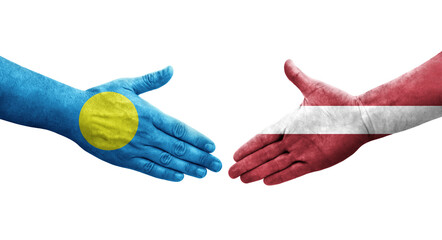 Handshake between Latvia and Palau flags painted on hands, isolated transparent image.