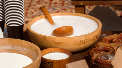Traditional Asian wooden utensils with mare's milk koumiss or camel milk from Adobe Stock Images.