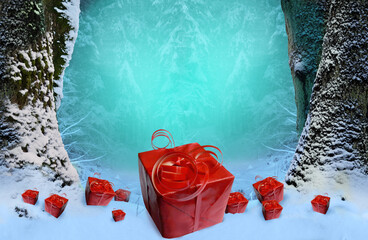 Red gift boxes with curly ribbons in snow on light blue hazy winter forest background with snowy trees. New Year holiday concept