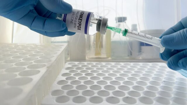 Preparation of the vaccination dose for booster shot for Smallpox and Monkeypox (MPXV). Doctor with vial and syringe preparing doses of monkeypox disease MPXV vaccine
