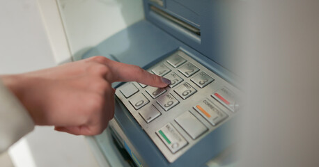 close up young woman hand pressing on atm machine for unlock password or counting money , business...