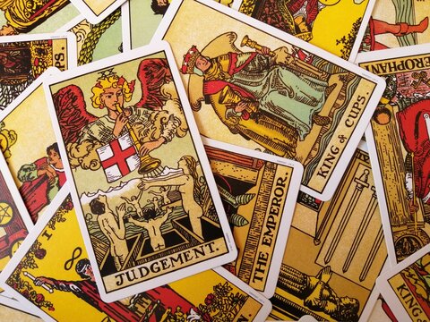 Picture of the Judgement  tarot card from the original Rider Waite tarot deck with mixed tarot cards in the background