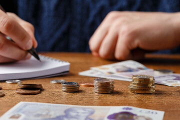 man counting monthly expenses, bills, money and payments doing paperwork, finance concept, Devon,...
