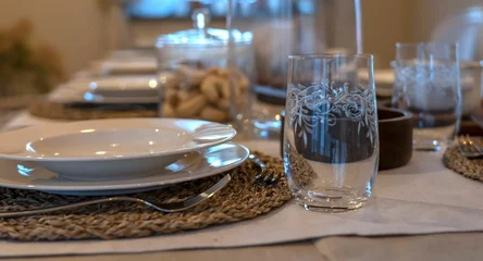 Keuken spatwand met foto Dinner table with plates, glass cups, and cutlery on a table © Dejan Mesel/Wirestock Creators