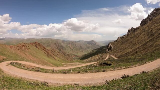 Timelapse video of the 33 turns zig zag road climbing up to Song Kul, a high alpine lake in the Tian Shan Mountains of Kyrgyzstan