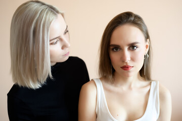 Two young women on a light background.