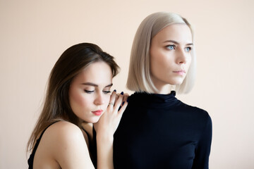 Two young women on a light background.