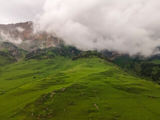 Fototapeta na wymiar Amazing mountain landscape. Beautiful clouds, fields, mountains. Aerial view