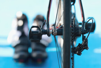 Triathlon bike the transition zone, detail bicycle derailleur. In the background running shoes and...
