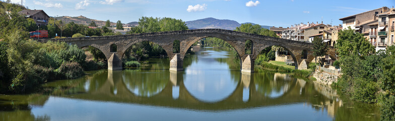 Fototapeta na wymiar Puente la Reina, Spain - 31 Aug, 2022: Arches of the roman Puente la Reina foot bridge, Navarre, Spain