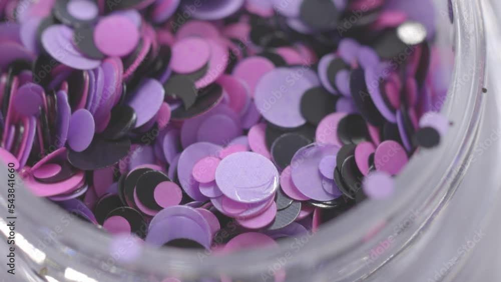 Poster purple sequins in a jar rotate in a circle