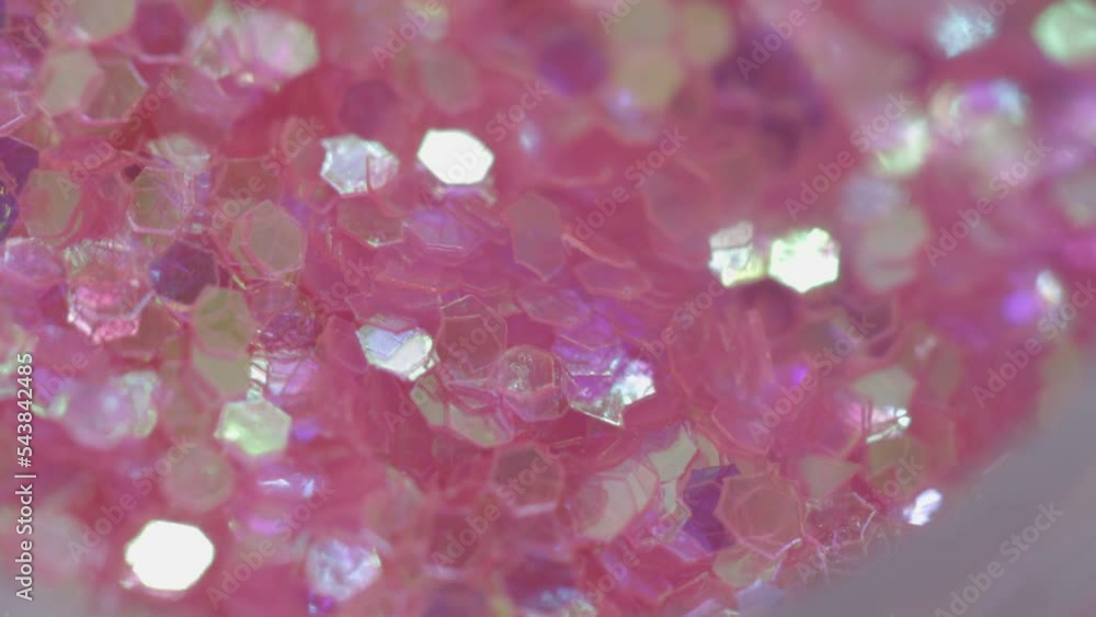 Poster pink sequins in a jar rotate in a circle
