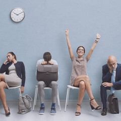 Successful woman celebrating with raised arms