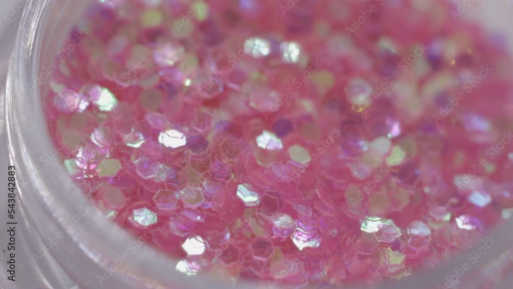Poster pink sequins in a jar rotate in a circle