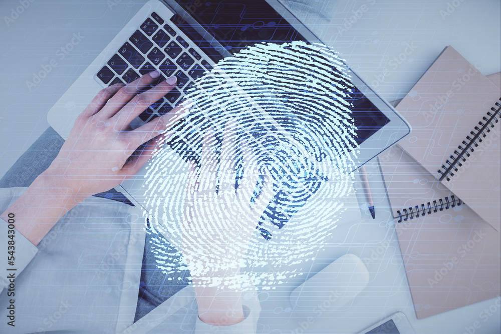 Poster double exposure of woman hands working on computer and fingerprint hologram drawing. top view. digit