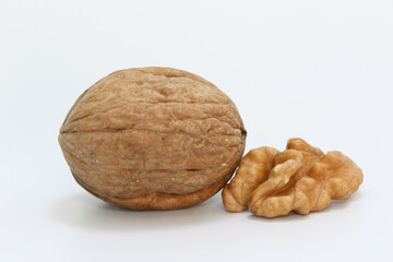 whole walnuts and walnut kernels isolated on white background