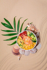 Hawaiian traditional food poke bowl on sand