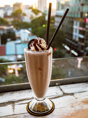 Ice coffee in a tall glass with cream