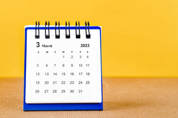 The March 2023 Monthly desk calendar for 2023 on yellow background.