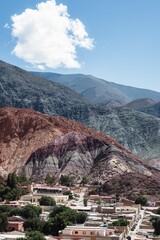 Vertical shot of the Hill of Seven Colours mountains in the background of tiny Purmamarca, Argentina