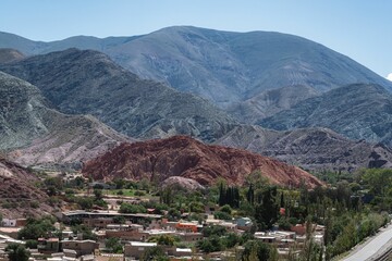 Scenic shot of the Hill of Seven Colours mountains in the background of tiny Purmamarca, Argentina