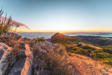 Madeira sunrise photographed from the beautiful mountain landscape of Pico do Ariero. Pico do...