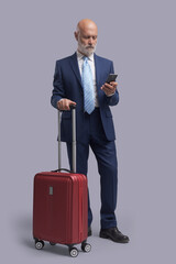 Businessman traveling and using his smartphone